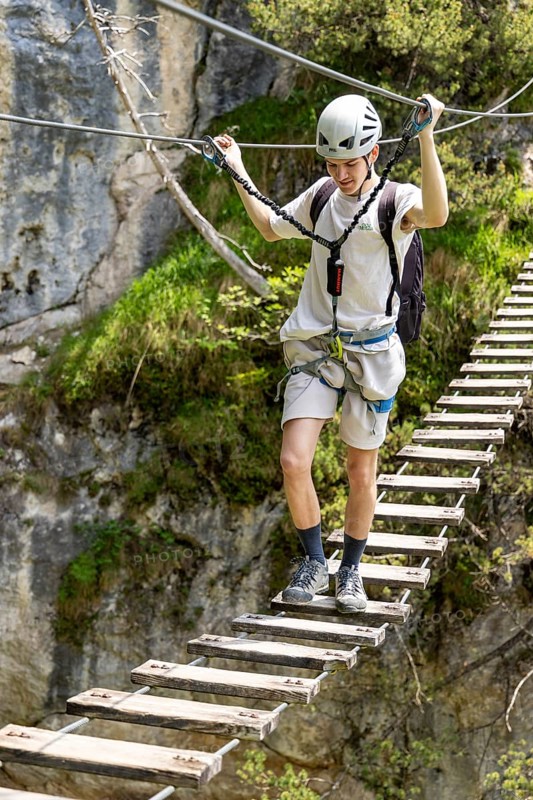 Mountaineer climbing over a suspension bridge on the Isidor via ferrata, GrÃ¼nstein, Schönau am Königssee, Berchtesgadener Land, Upper Bavaria, Bavaria, Germany