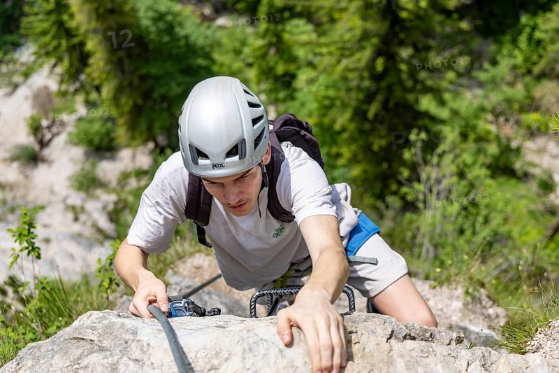 Mountaineer climbing over a steep ladder in the Isidor via ferrata, GrÃ¼nstein, Schönau am Königssee, Berchtesgadener Land, Upper Bavaria, Bavaria, Germany