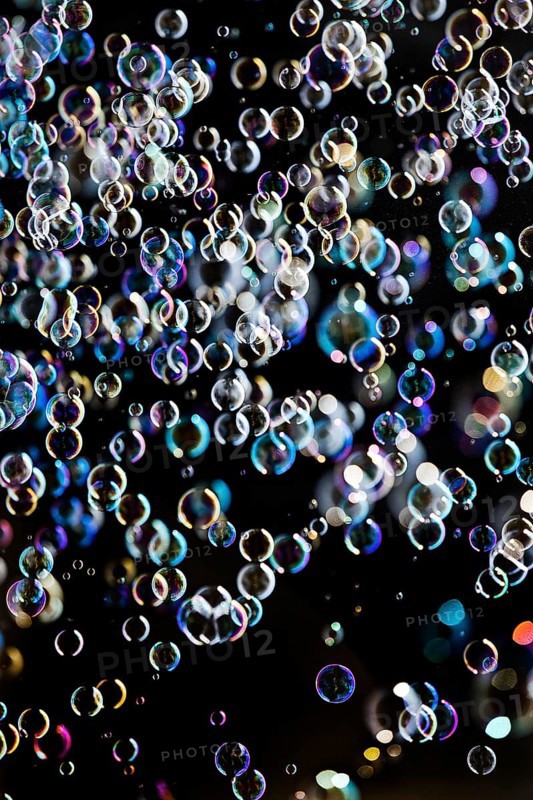 Many, small iridescent and floating soap bubbles against a black background, Recklinghausen, North Rhine-Westphalia, Germany