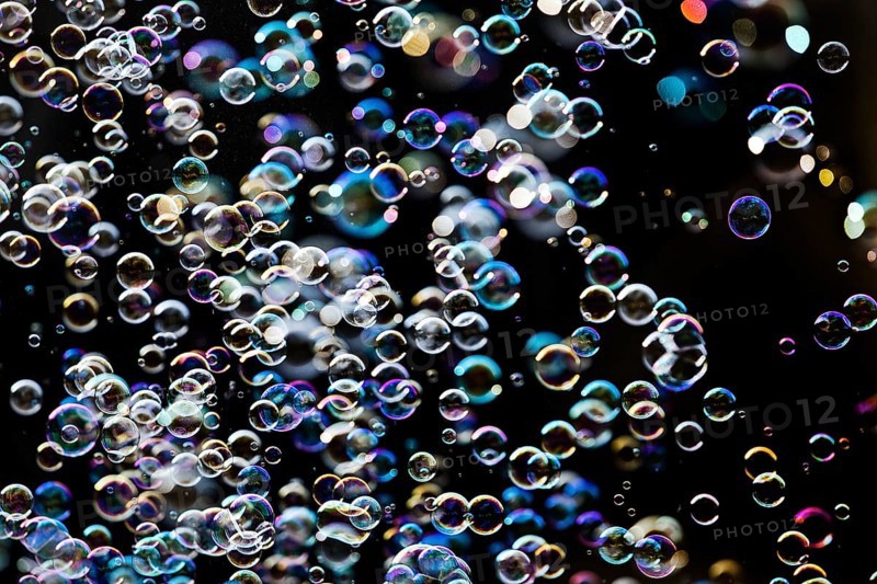 Many, small iridescent and floating soap bubbles against a black background, Recklinghausen, North Rhine-Westphalia, Germany