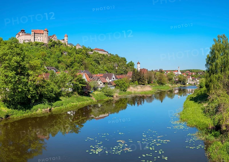 View over the river Wörnitz with water lilies to the castle and the old town with the churches of St Barbara and Herz Jesu, Harburg, Donau-Ries, Swabia, Bavaria, Germany