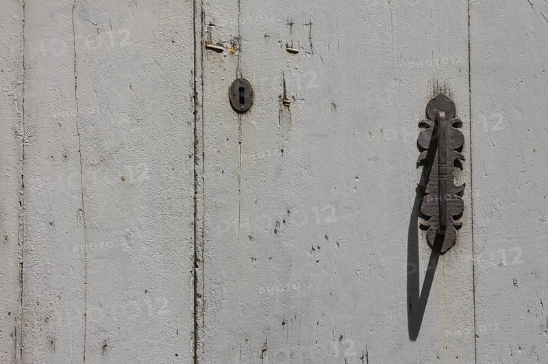 Metal fittings on an old wooden door, Tuscany, Italy