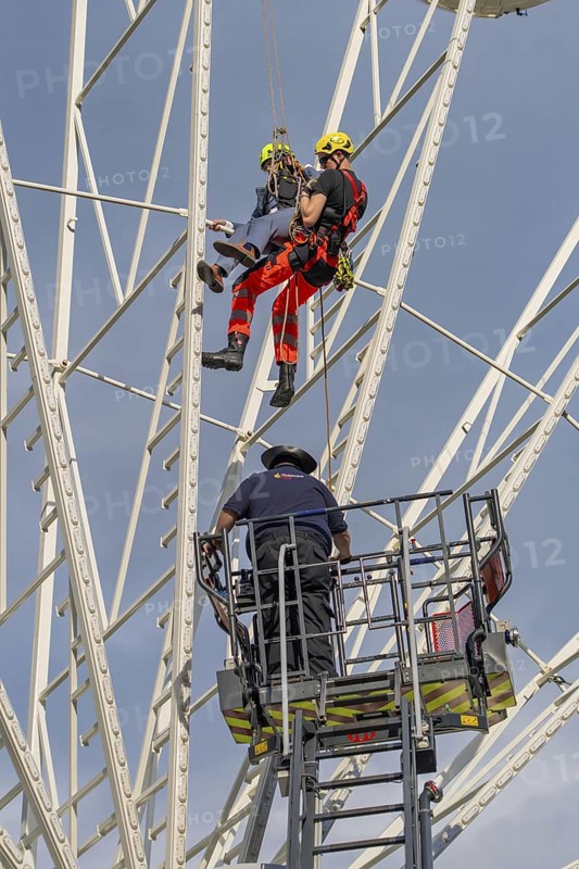 Firefighters on a rescue mission on a Ferris wheel with crane support, fire brigade exercise for gondola rescue, Germany