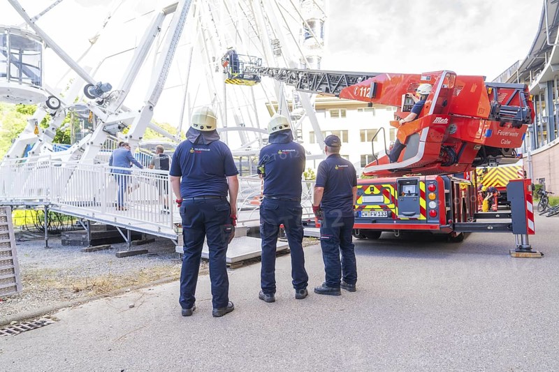 Firefighters look at an emergency situation on a Ferris wheel with a lifting platform, Fire brigade exercise for gondola rescue on a Ferris wheel, Calw, Germany