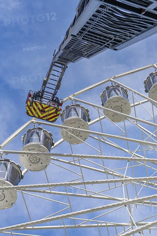 Fire brigade ladder reaches up to the Ferris wheel, ready for an operation in the clear sky, fire brigade exercise for gondola rescue Ferris wheel, Calw, Germany