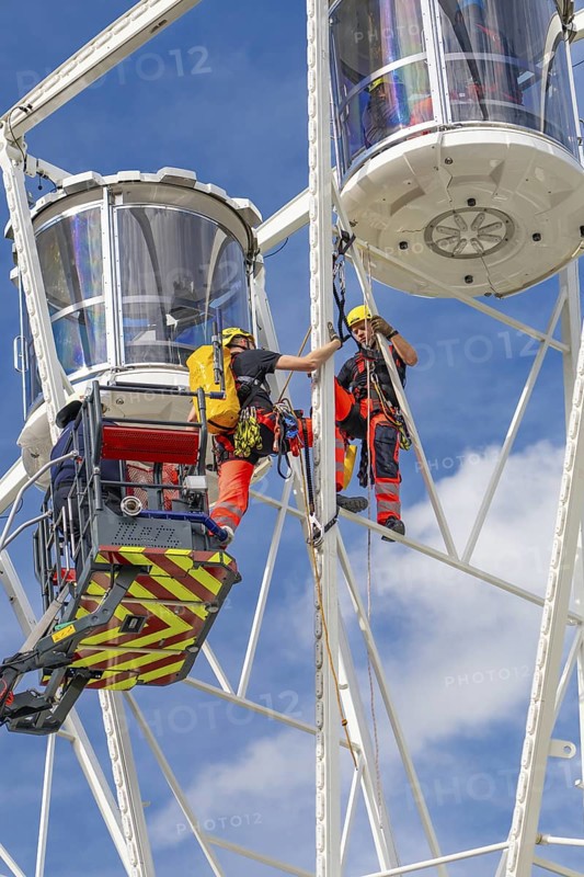 Firefighters on a rescue mission high up on a Ferris wheel, Fire brigade exercise for gondola rescue Ferris wheel, Calw, Germany