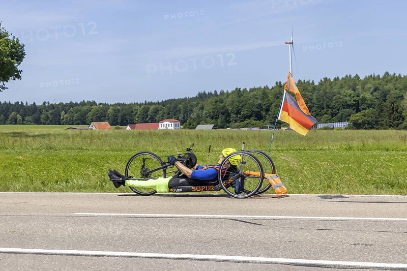 Man with handbike travelling on a country road. Special bike with manual drive for disabled people. Merklingen, Baden-WÃ¼rttemberg, Germany