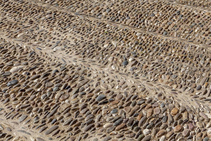 Street paving made of coloured pebbles, background, texture, Andalusia, Spain