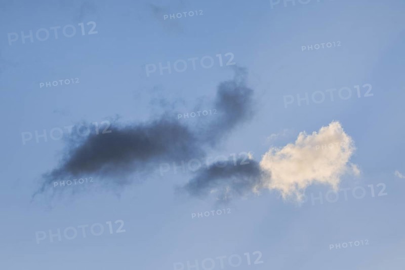 Black and white clouds in the blue evening sky