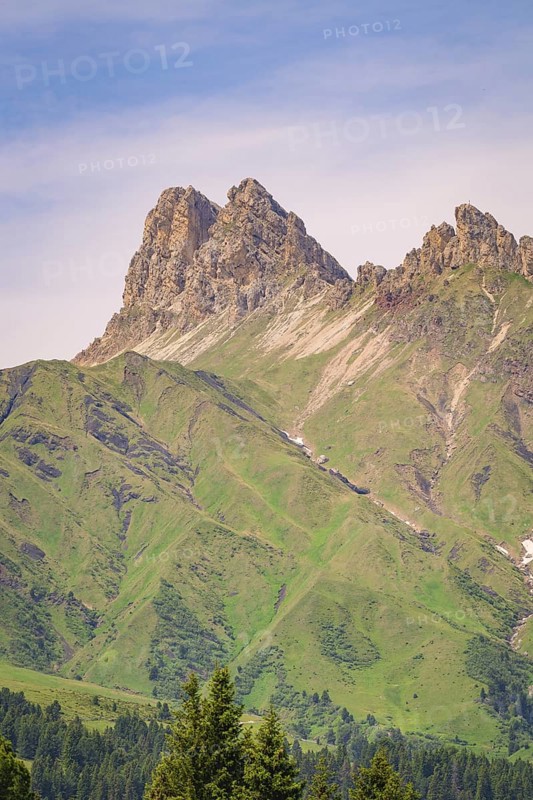 Massive mountain peaks with green slopes and minute skies over the landscape, hike to the Schlehrn, Alpe di Siusi, Dolomites, South Tyrol, Italy