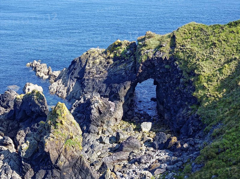 Rocky coast and rock gate on the south-east coast near the southern tip of Cornwall on the English Channel. Cadgwith, Cornwall, South West England, Great Britain
