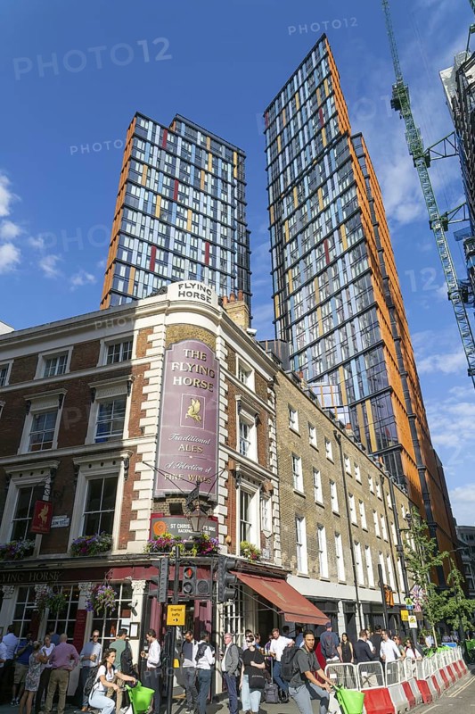 Tower block apartments of One Crown Place rise high above older properties, Sun Street, City of London, England, UK - The Flying Horse pub