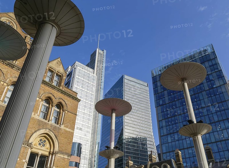 Looking up at office blocks in blue sky from forecourt of Liverpool Street station, London, England, UK