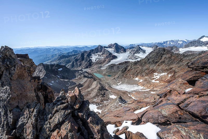 View of mountain basin with blue glacier lakes, behind summit Becher with Becherhaus, glacier Ãœbeltalferner and summit Königshofspitz, descent from summit Wilder Freiger to Roter Grat, Stubai Alps, South Tyrol, Italy