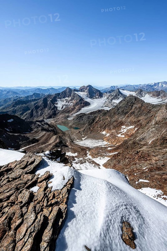 View of mountain basin with blue glacier lakes, Ãœbeltalferner glacier and Königshofspitz summit in the background, view with mountain panorama into the Ridnaun valley, descent from the Wilder Freiger summit, Stubai Alps, South Tyrol, Italy