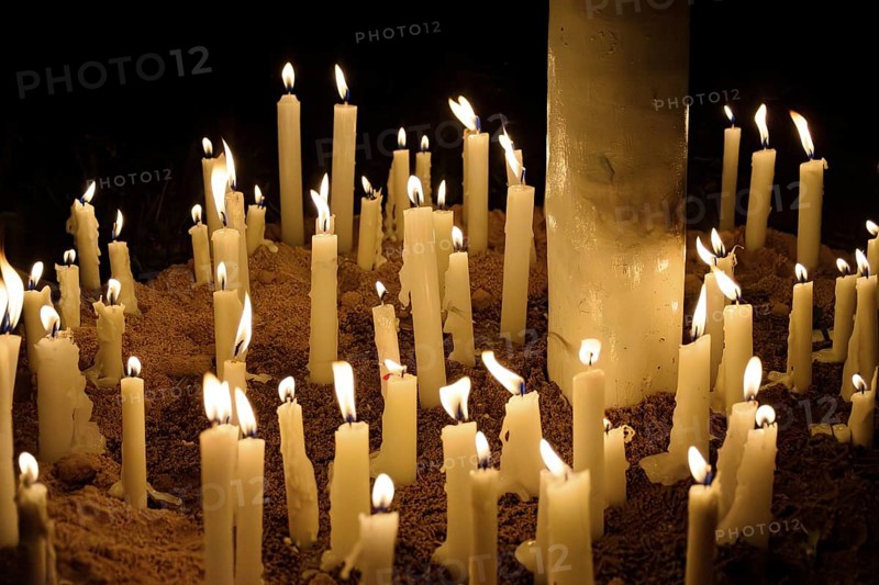 Candles placed by the faithful as offerings during their prayers