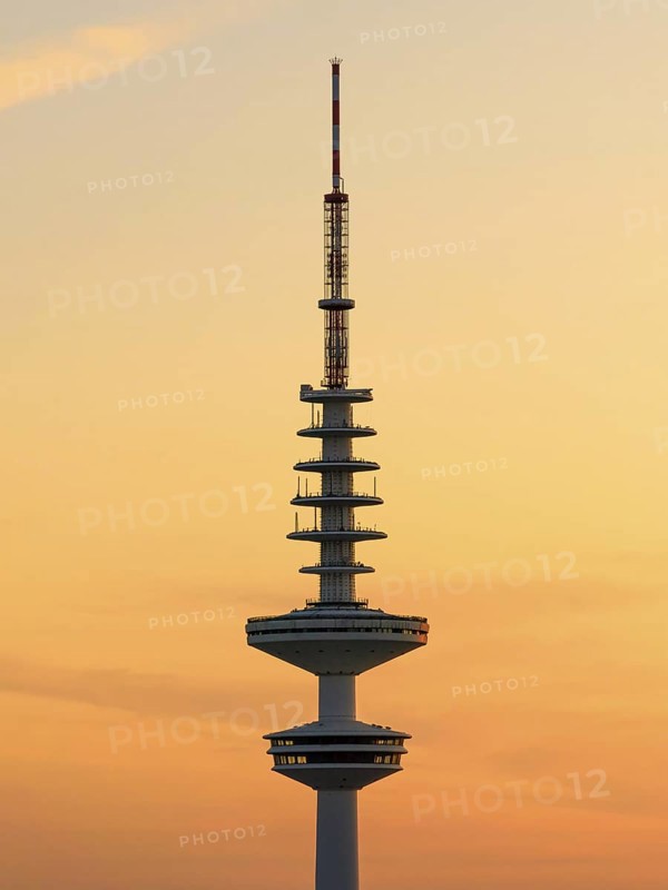 Television tower Heinrich-Hertz-Turm (Telemichel) in front of a yellow sky at sunset, Hamburg, Germany