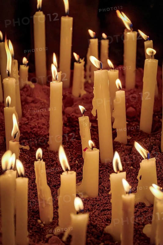 Candles burning on the dirt floor during a typical Brazilian religious festival, Minas Gerais, Brazil