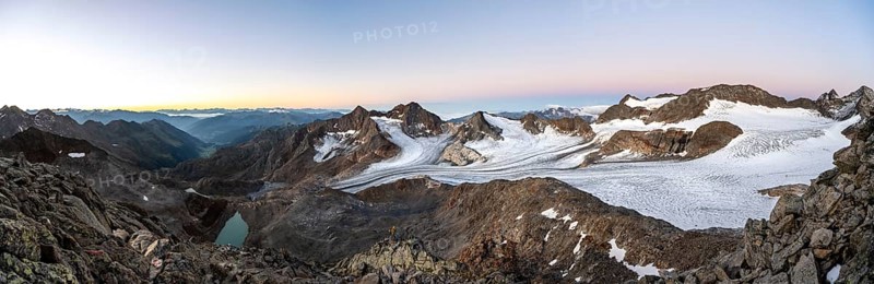 Mountain panorama, picturesque high mountain landscape at sunrise, blue glacial lakes, glaciers and rocky mountain peaks, view of the Königshofspitz and Sonklarspitze mountain peaks and Schwarzwandspitz with Ãœbeltalferner glacier, Stubai Alps, South Tyrol, Italy