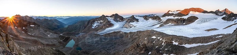 Panorama at sunrise with sun star, high mountain landscape, view of blue glacial lakes, mountain peaks Königshofspitz and Hofmannspitze with glacier of the Ãœbeltalferner, Stubai Alps, South Tyrol, Italy