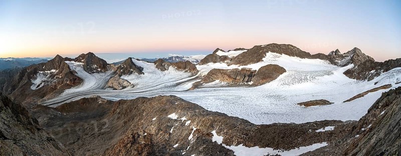 Mountain panorama, picturesque high mountain landscape at sunrise, glacier and rocky mountain peaks, view at Becher of mountain peaks Königshofspitz and Sonklarspitze and Schwarzwandspitz with glacier Ãœbeltalferner, Stubai Alps, South Tyrol, Italy