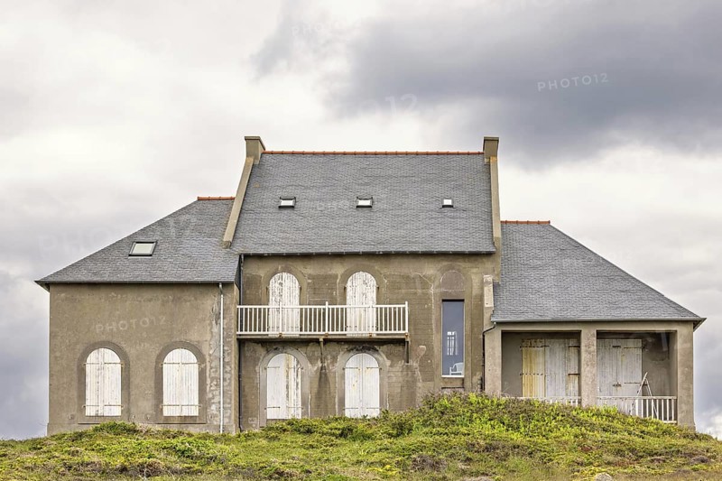 Old house with closed window shutters on a hill at a coastal area, Camaret-sur-Mer, Crozon Peninsula, Bretagne, France