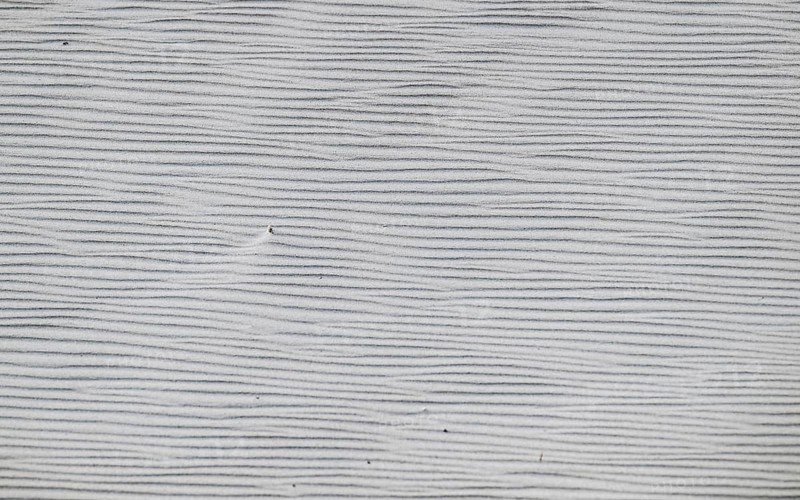 Close-up of a sandy area with fine, wavy lines in shades of grey, near Hvide Sande, North Sea, Denmark
