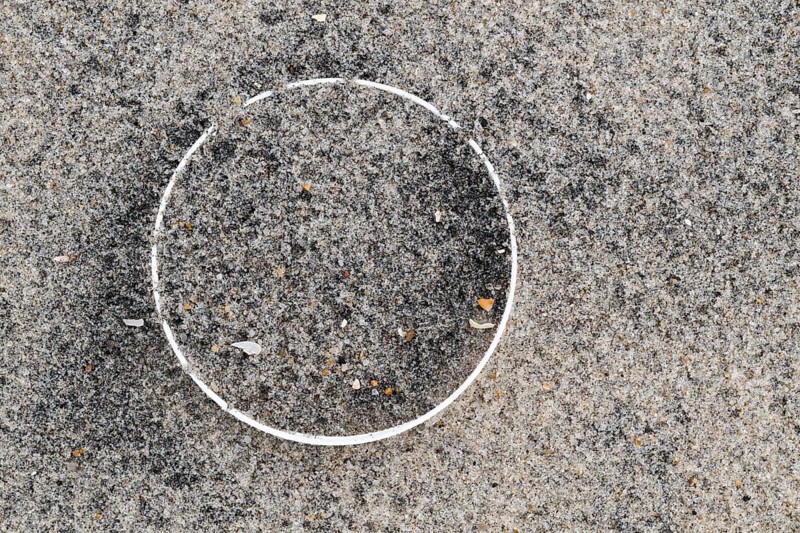Remains of a plastic bottle in the sand on the beach, symbolising environmental pollution and human waste, RingkÃ¸bing Fjord, Jutland, Denmark