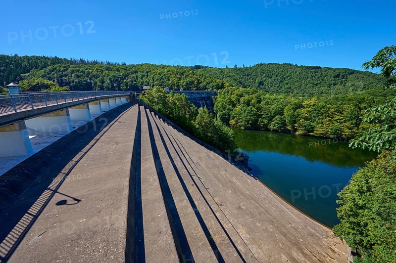 View of a large dam with dense forest under a clear blue sky, summer, Urft dam wall, Obersee, Urftsee, Schleiden, Eifel National Park, Eifel, North Rhine-Westphalia, Germany