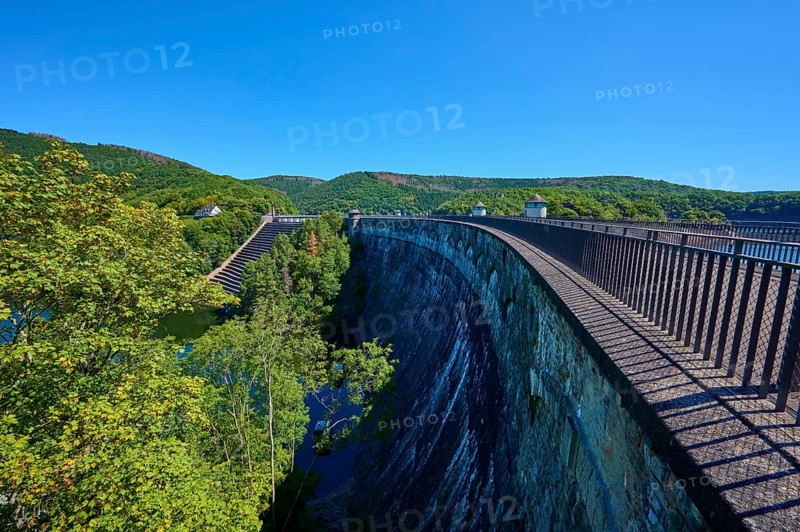 High view of a large dam with neighbouring forest and clear sky, summer, Urft dam wall, Obersee, Urftsee, Schleiden, Eifel National Park, Eifel, North Rhine-Westphalia, Germany