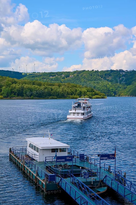 A passenger ship moves away from the landing stage, on a large lake, summer, Rursee, Rurtalsperre, Heimbach, Simmerath, Eifel National Park, North Rhine-Westphalia, Germany
