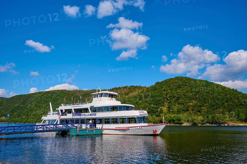Passenger ship at the jetty, surrounded by green hills and blue sky, summer, Rursee, Rurberg, Simmerath, Eifel National Park, North Rhine-Westphalia, Germany
