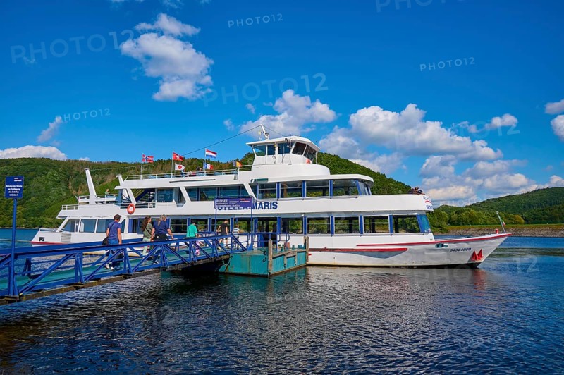 Passenger ship lying at a jetty on a lake with a deep blue sky and fleecy clouds, summer, Rursee, Rurberg, Simmerath, Eifel National Park, North Rhine-Westphalia, Germany