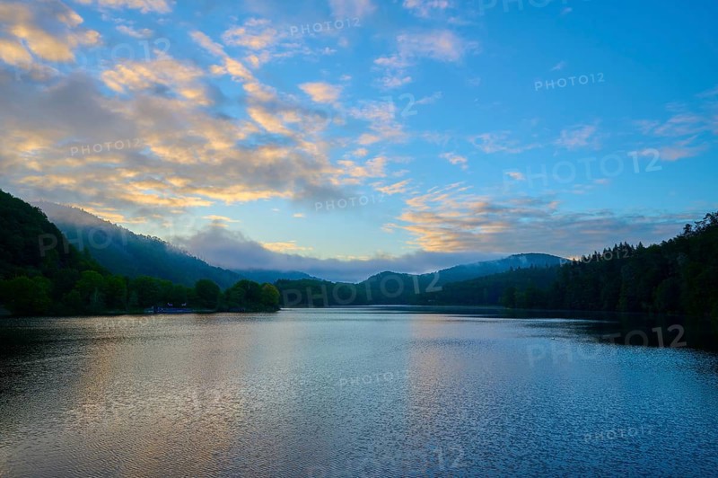 Gentle morning colour reflected on the quiet lake, surrounded by hills and clouds, summer, Rursee, Obersee, Rurberg, Simmerath, Eifel National Park, North Rhine-Westphalia, Germany