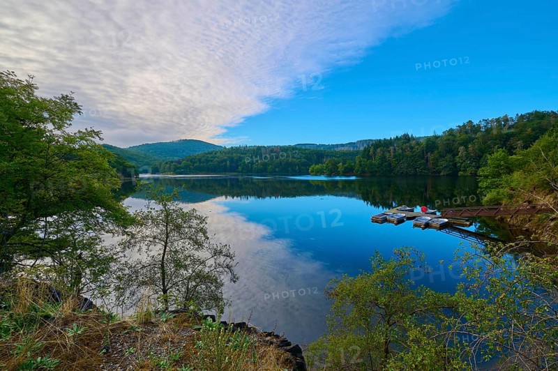 Clear water reflection of a wooded mountain on the lake, summer, Rursee, Obersee, Simmerath, Eifel National Park, North Rhine-Westphalia, Germany
