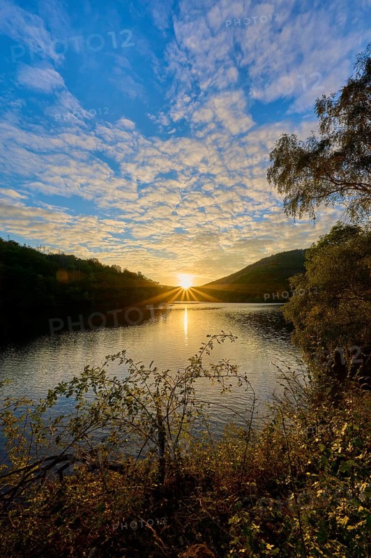 Sunset over a lake, dramatic cloud formations and golden light on the water, summer, Rursee, Obersee, Simmerath, Eifel National Park, North Rhine-Westphalia, Germany