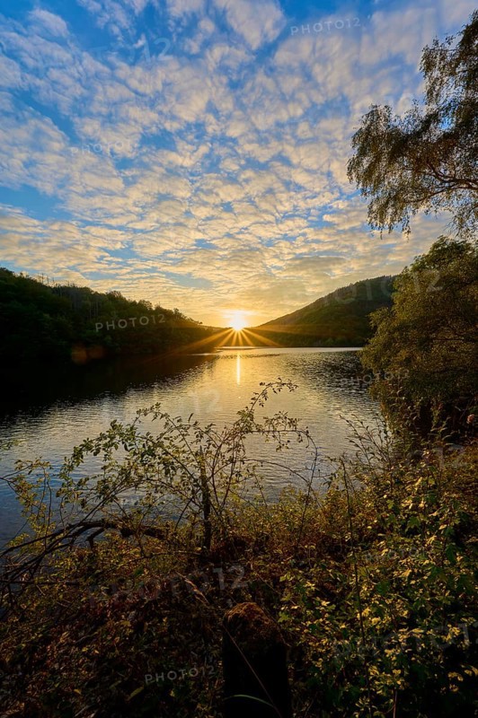 Golden sunbeams spread across the lake, dramatically surrounded by clouds, summer, Rursee, Obersee, Simmerath, Eifel National Park, North Rhine-Westphalia, Germany