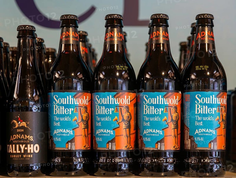 Adnams beer products on display inside brewery shop, Southwold, Suffolk, England, UK - Southwold bitter bottles
