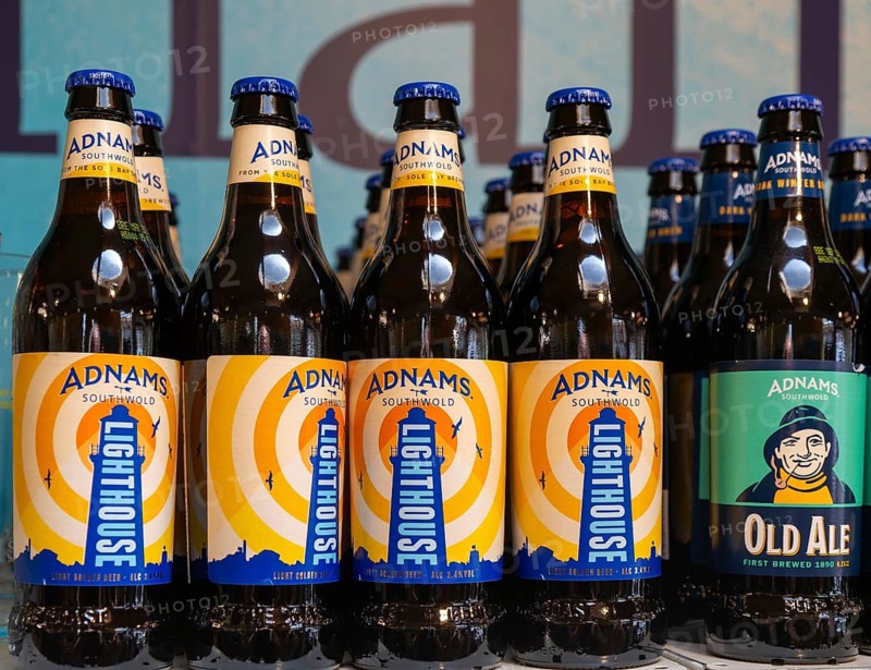 Adnams beer products on display inside brewery shop, Southwold, Suffolk, England, UK - Lighthouse beer bottles