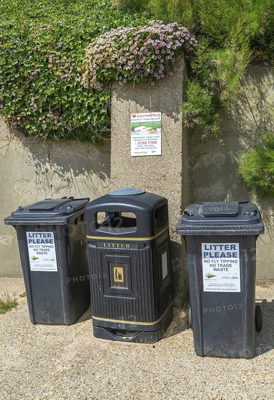 Litter rubbish waste bins and notice about littering fines, Southwold, Suffolk, England, UK