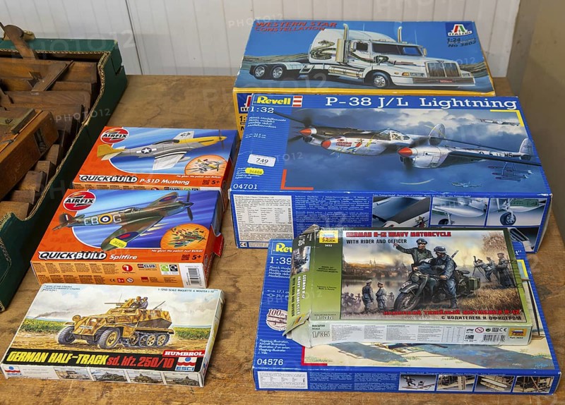 Boxes of Revell and Airfix military vehicles and planes scale models on display at auction, UK