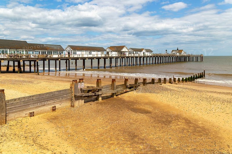 Wooden groyne running down sandy beach near pier, Southwold, Suffolk, England, UK