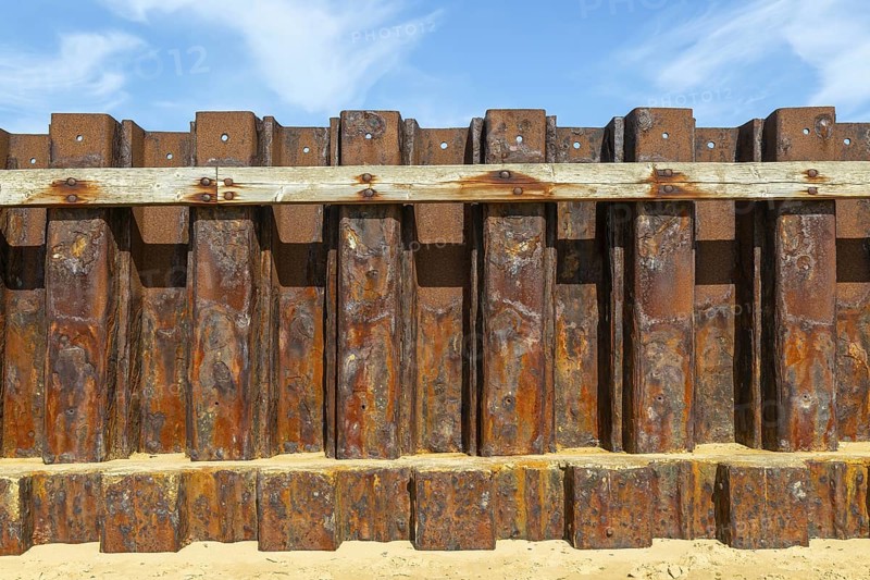 Old rusty steel sheet piling sea wall coastal defence, River Deben, Bawdsey, Suffolk, England, UK