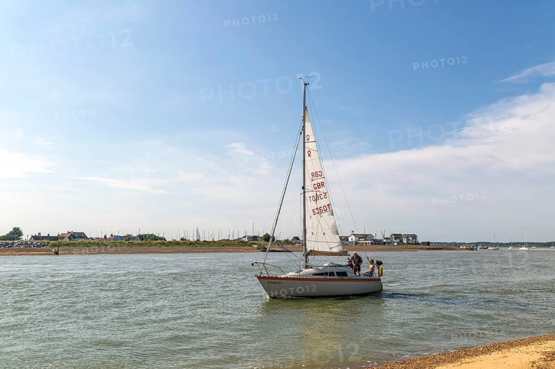 Sailing boat yacht at mouth of River Deben estuary, Bawdsey Quay, Suffolk, England, UK