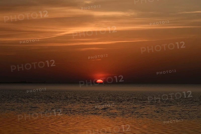 Atmospheric sunset... Cuxhaven, North Sea, in calm weather, glowing red sun sinking into the sea, calm sea, great light, absolute silence, Wadden Sea off Lower Saxony, atmospheric picture, local nature, Lower Saxony Wadden Sea National Park, North Sea near Cuxhaven, Duhnen, Lower Saxony, Germany, Western Europe