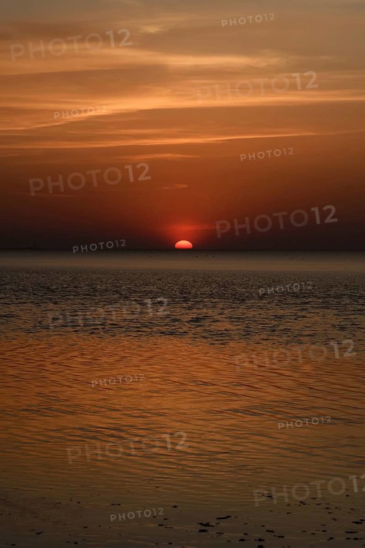 Atmospheric sunset... Cuxhaven, North Sea, in calm weather, glowing red sun sinking into the sea, calm sea, great light, absolute silence, Wadden Sea off Lower Saxony, atmospheric picture, local nature, Lower Saxony Wadden Sea National Park, North Sea near Cuxhaven, Duhnen, Lower Saxony, Germany, Western Europe