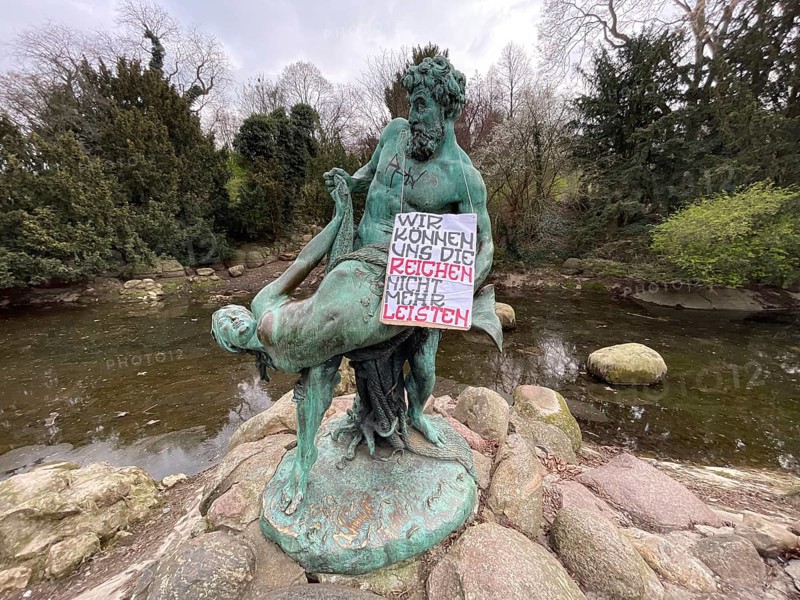 We can no longer afford the rich. Left-wing protest against wealth. Social protest. Funny, satire, graffiti on the bronze sculpture by Ernst Herter on GroÃŸbeerenschraÃŸe, Viktoriapark, Friedrichshain-Kreuzberg district, social issue, wealth and poverty