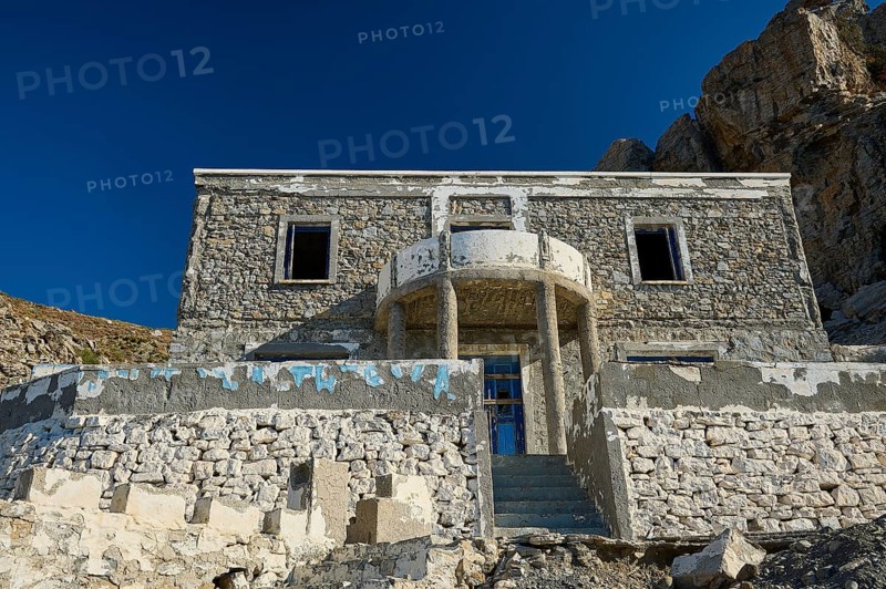 Old stone house against an imposing rocky backdrop, historic and sunlit, Embros Thermal Baths, Kos, Dodecanese, Greek Islands, Greece