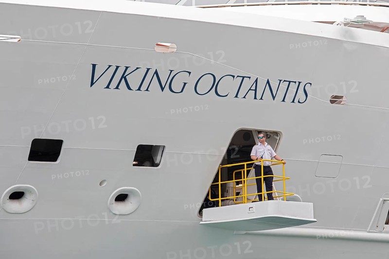 Detroit, Michigan - The Viking Octantis luxury cruise ship in Detroit on a cruise through the Great Lakes. A crew member keeps watch as the ship prepares to leave the dock