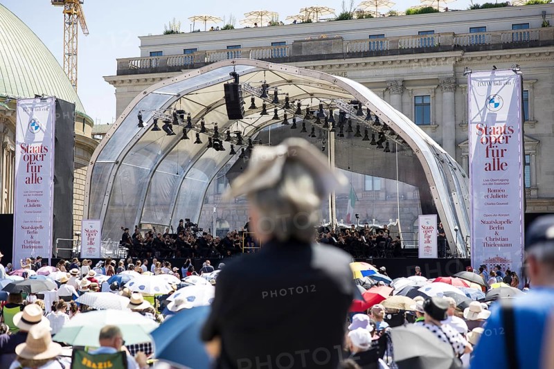A visitor protects himself from the sun with a newspaper on his head at the Staatsoper fÃ¼r alle, a free open-air concert with conductor Christian Thielemann and the Staatskapelle Berlin on Berlin's Bebelplatz, Berlin, 22 June 2025